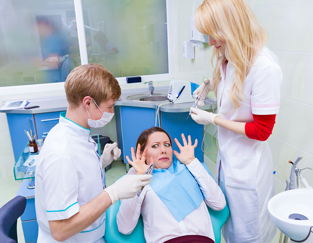 Closeup,portrait,young,terrified,girl,woman,scared,at,dentist,visit,